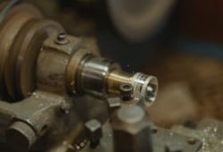 Detailed view of a metal lathe working in an industrial workshop environment.