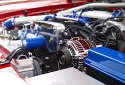 Detailed view of a clean modern car engine with vibrant colored components and sleek design.